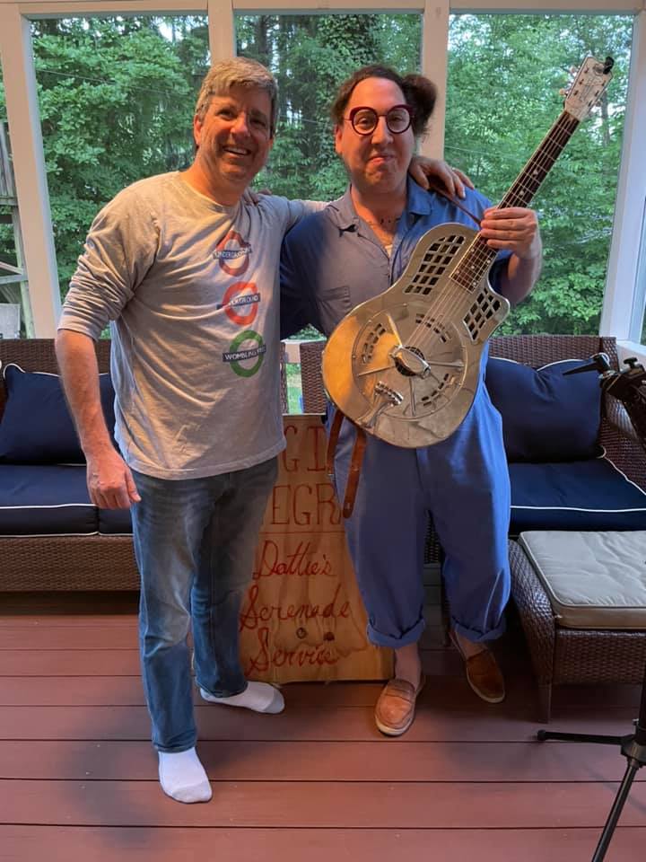 Dot Levine singing in a screened in porch while playing their nickel-played brass resonator guitar