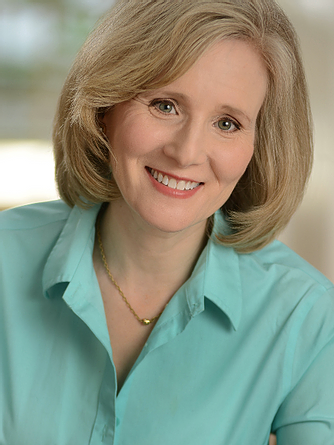 Headshot of Diane Gaary, smiling white woman in teal shirt with blurred background